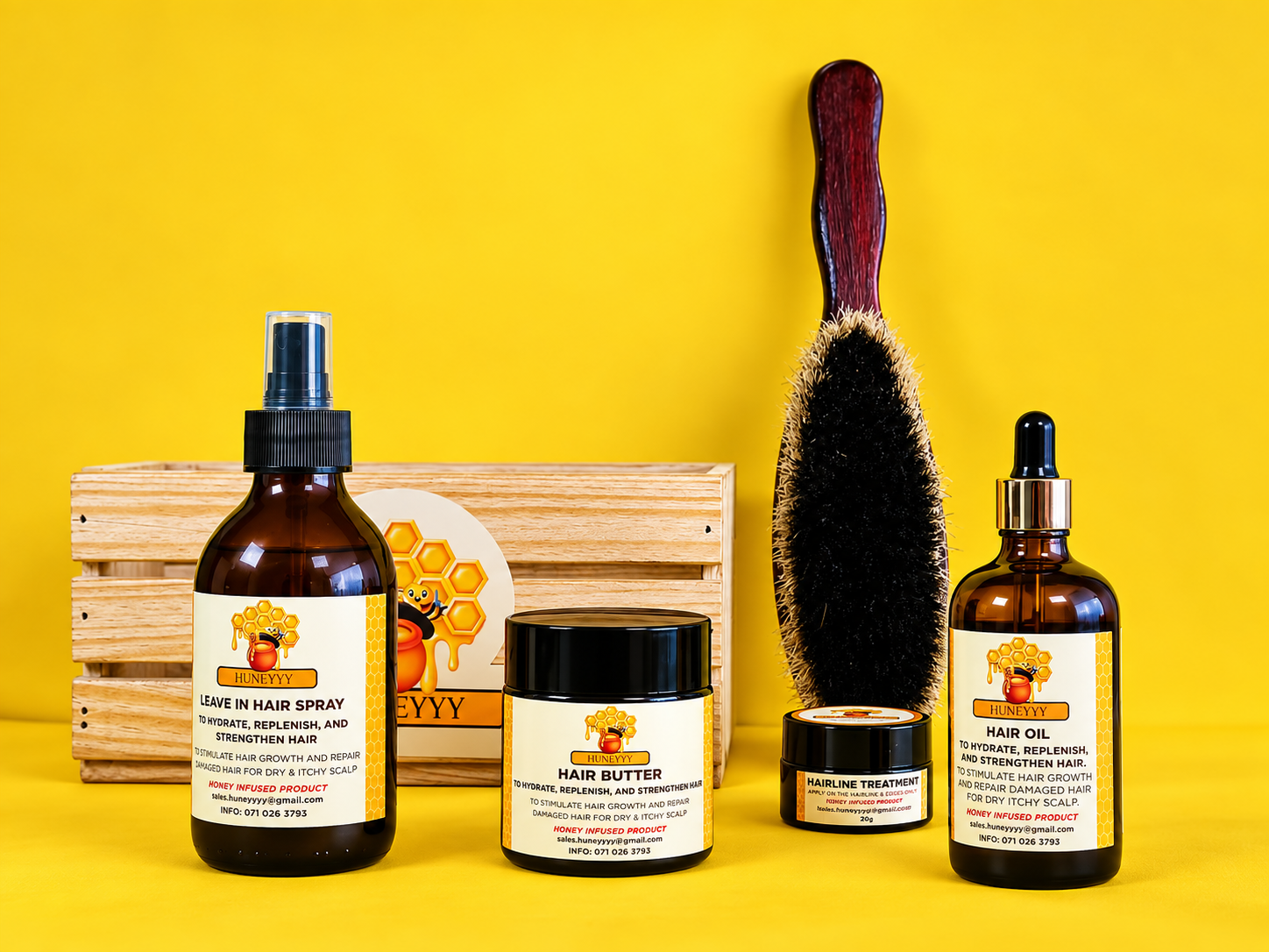 Huneyyy honey-infused haircare products arranged with a brush