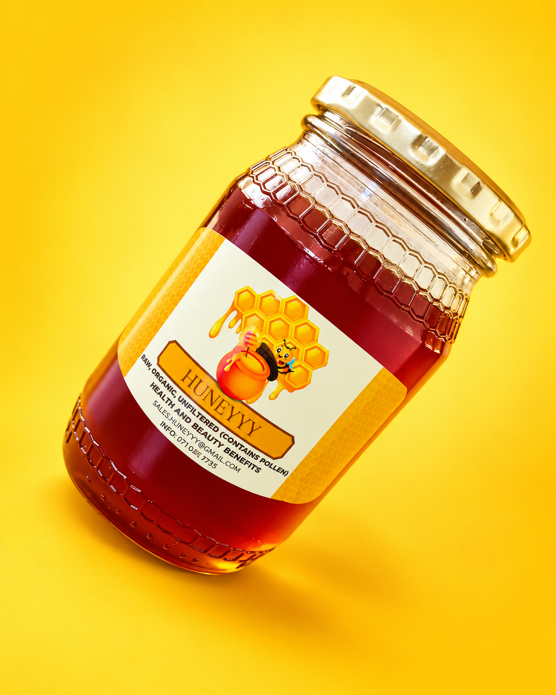 Huneyyy honey bottle on a yellow studio background